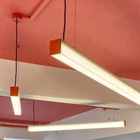 Detailed view of the red profile system – linear LED ceiling luminaire for architecturally planned office interiors